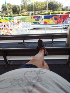 My Disney experience in a nutshell.  Looking past the belly and feet to watch the children ride.