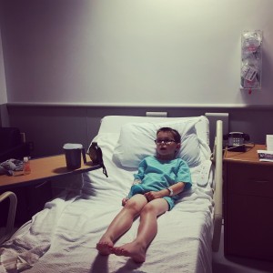 Looking somewhat wee and helpless in his hospital bed, but thrilled by the on demand tv