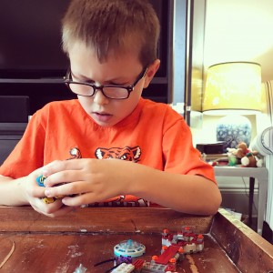 Liam focuses on Legos.